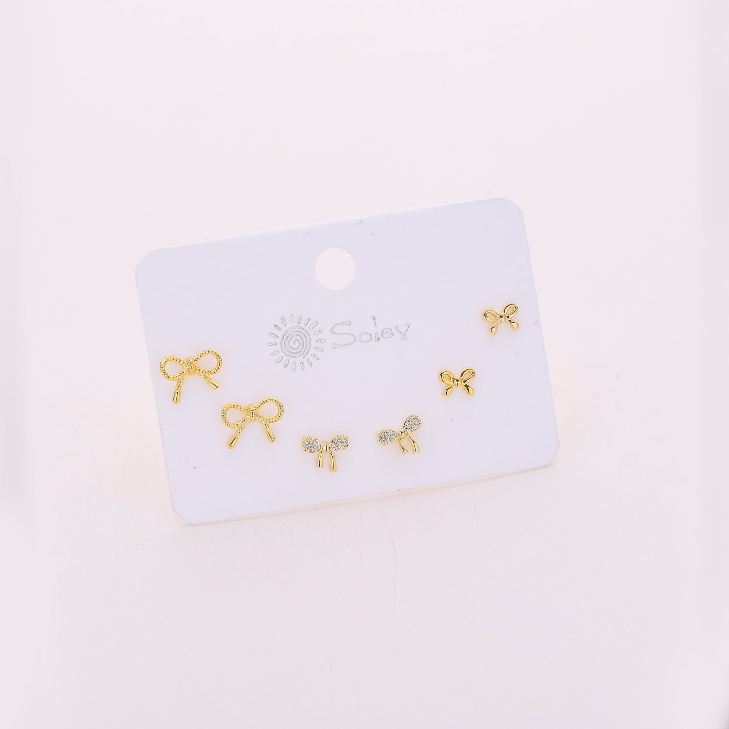 3 pares / broquel / 3 moños cristal / dorado