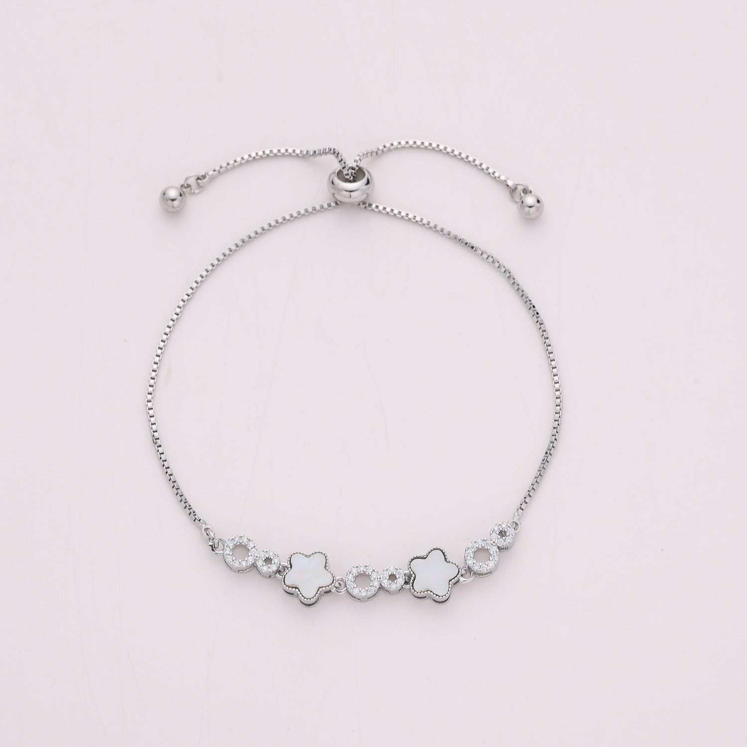 CAD BOX / 2 FLORES MADRE PERLA /AROS CRISTAL / BROCHE BOLA CORREDIZA / PLATA
