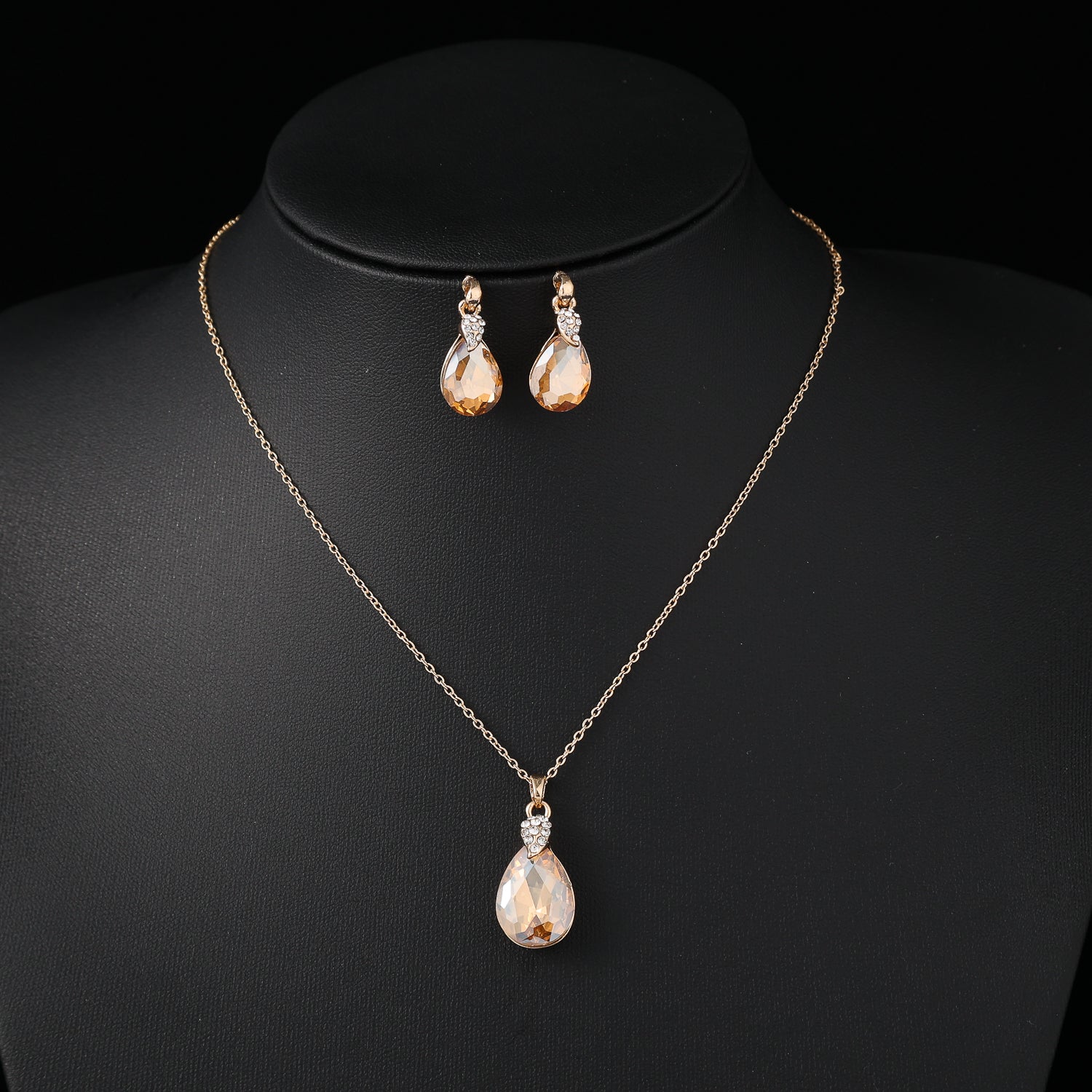 coll y are /cad del / gota ambar g / base cristal / arete gota / dorado
