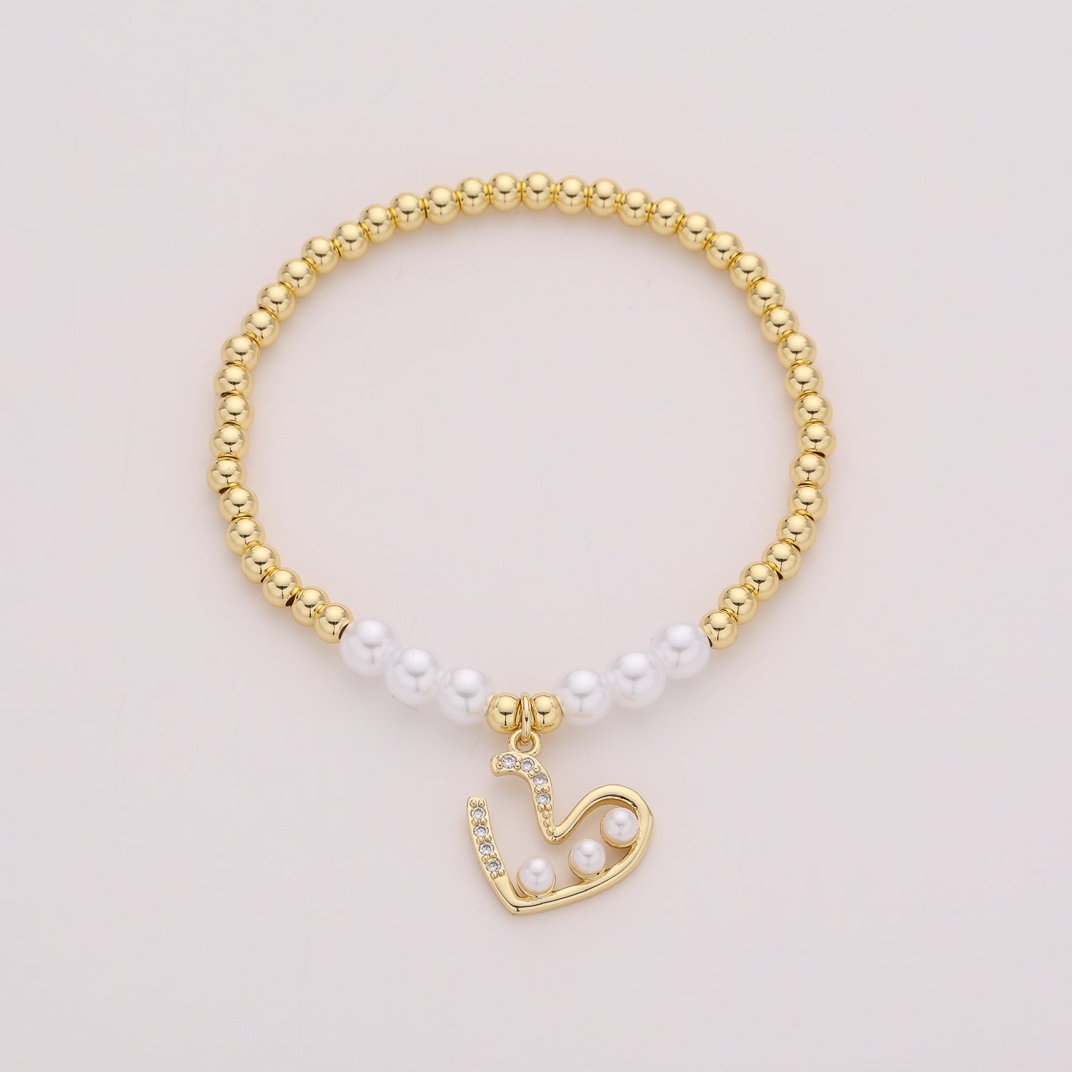 ELASTICO BOLAS DORADAS CON PERLAS / DIJE PERFIL CORAZON PERLA / DORADO